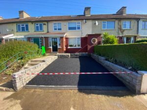 Asphalt driveway with Connemara walling completed 2